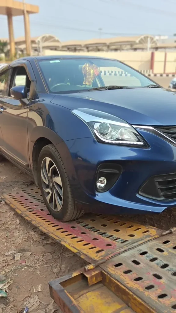 Car being loaded onto a car carrier for car transportation from Kakinada