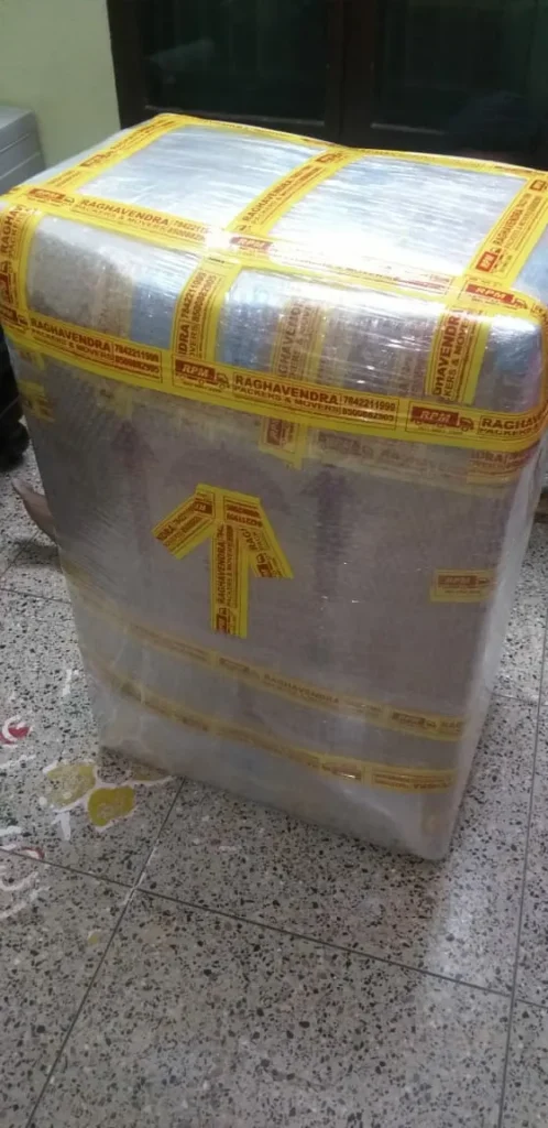 Fragile item packed in bubble wrap with this-side-up arrow tape by Raghavendra Packers and Movers