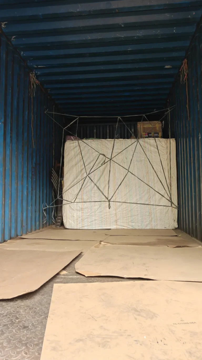 Mattress and furniture strapped securely inside a closed container truck for an intercity move from Kakinada
