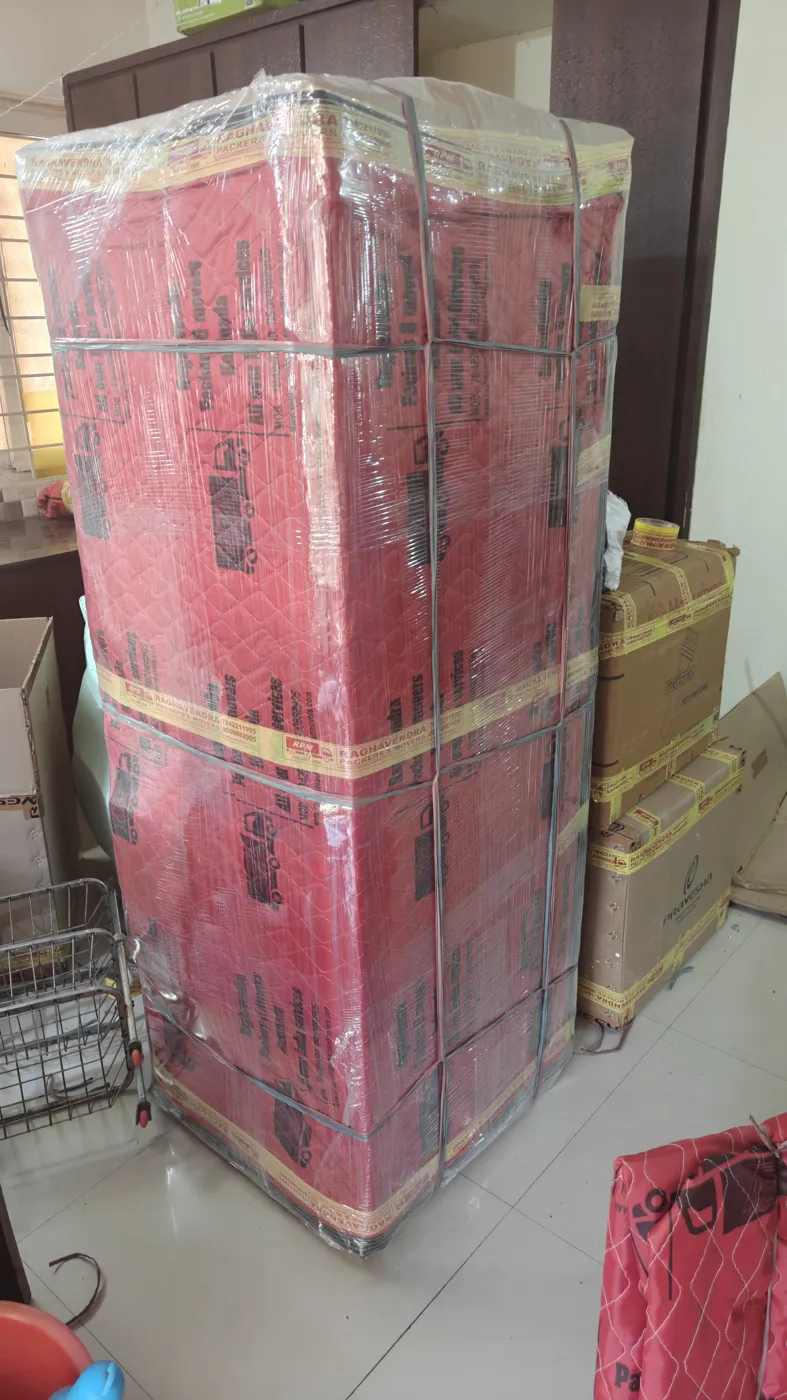 Refrigerator wrapped in Raghavendra Packers and Movers quilted cover and stretch film for house shifting in Kakinada