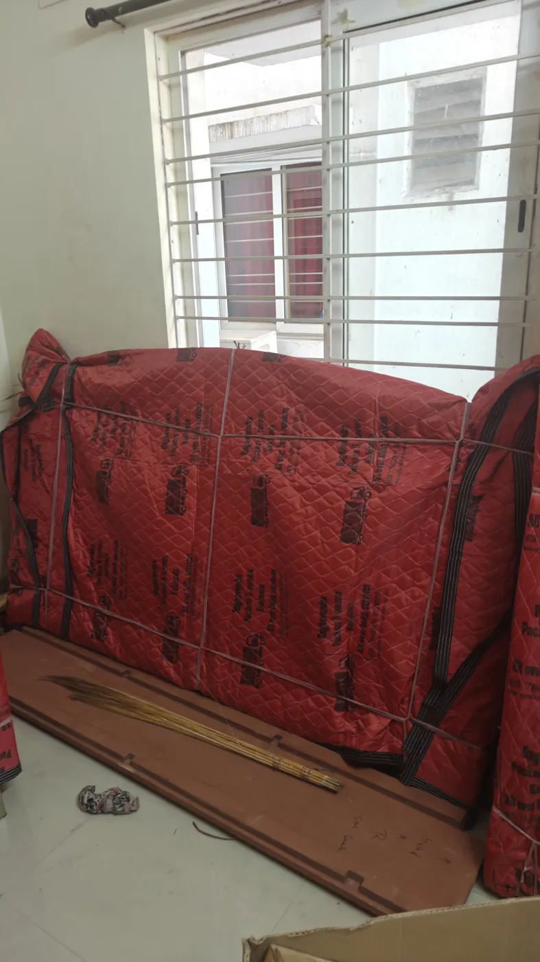 Sofa packed in a branded quilted cover by Raghavendra Packers and Movers during house shifting in Kakinada