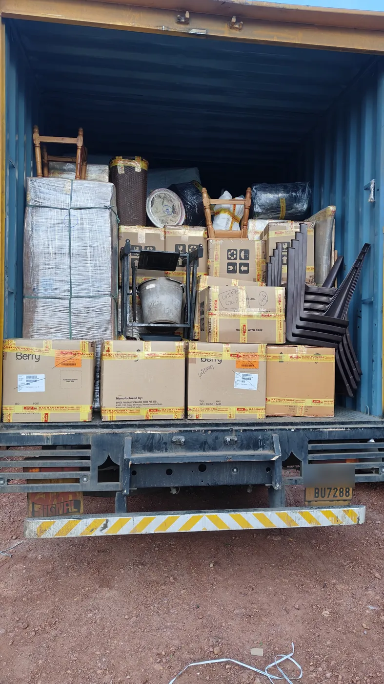 Cartons and furniture loaded in a container truck during house shifting by packers and movers in Kakinada