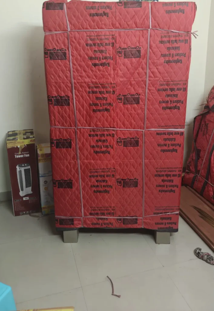 Wardrobe covered in quilted protective wrap by Raghavendra Packers and Movers, Kakinada