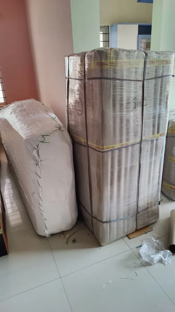 Wardrobe and sofa wrapped and strapped for safe house shifting in Kakinada